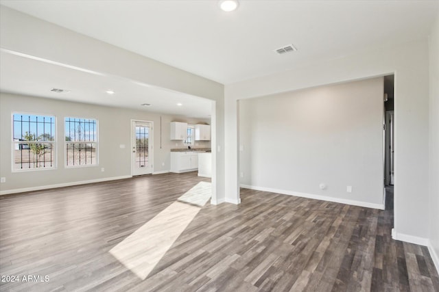 unfurnished living room with dark hardwood / wood-style floors