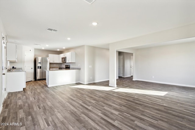 unfurnished living room featuring wood-type flooring