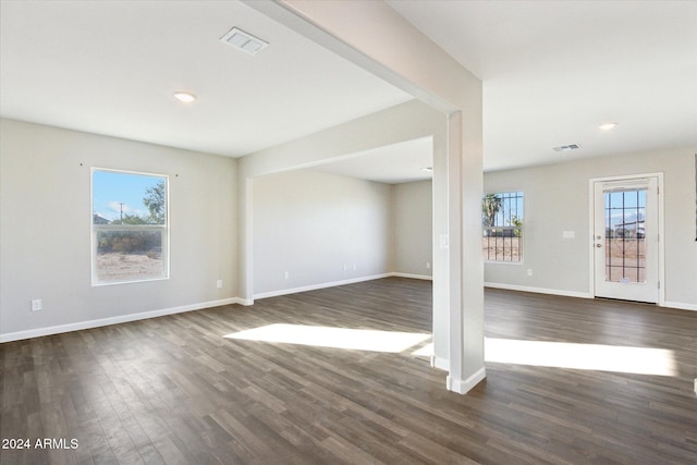 interior space with dark wood-type flooring and plenty of natural light