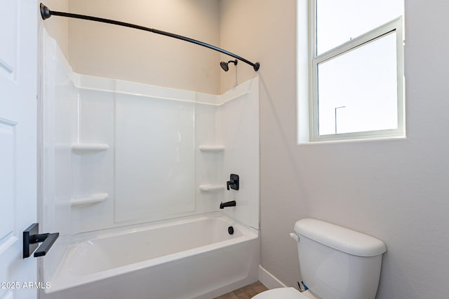 bathroom featuring  shower combination, toilet, and plenty of natural light