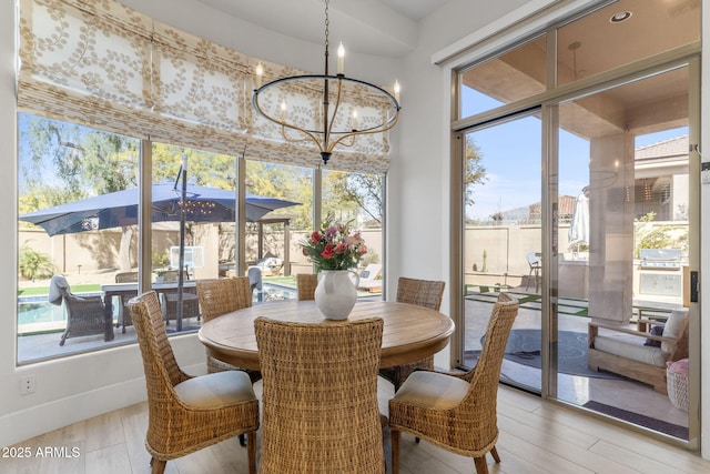 sunroom featuring an inviting chandelier