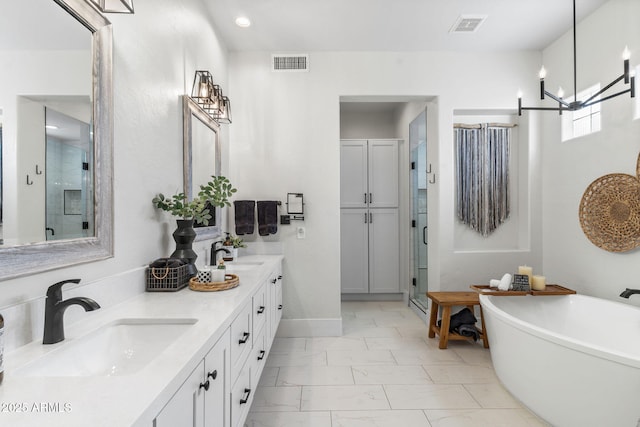 bathroom with a freestanding bath, a sink, visible vents, and a shower stall