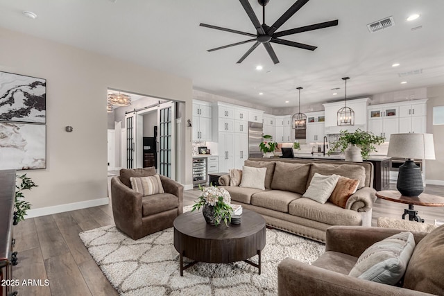 11385 N Luckenbach St, Surprise, AZ 85388 - living room featuring ceiling fan, baseboards, a chandelier, wood finished floors, and recessed lighting
