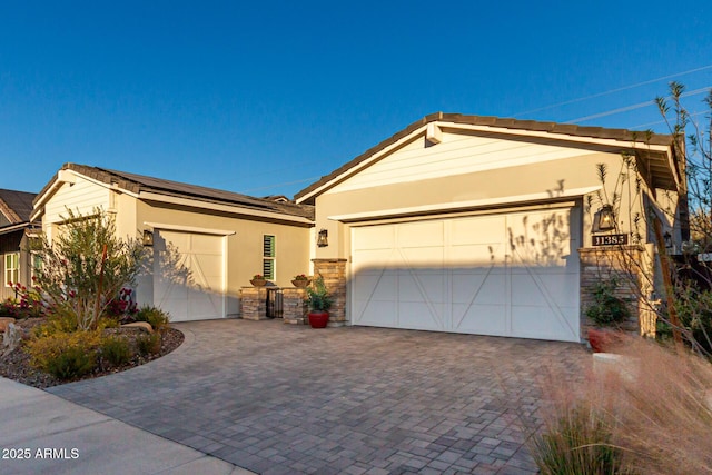 11385 N Luckenbach St, Surprise, AZ 85388 - ranch-style home with driveway, stucco siding, stone siding, and an attached garage