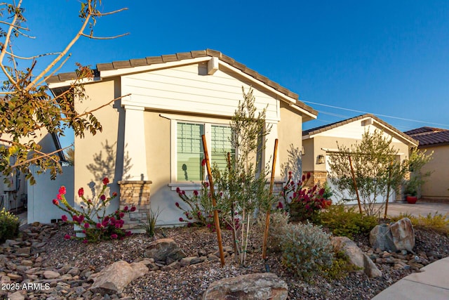 11385 N Luckenbach St, Surprise, AZ 85388 - view of front facade featuring a garage, stucco siding, concrete driveway, and a tiled roof