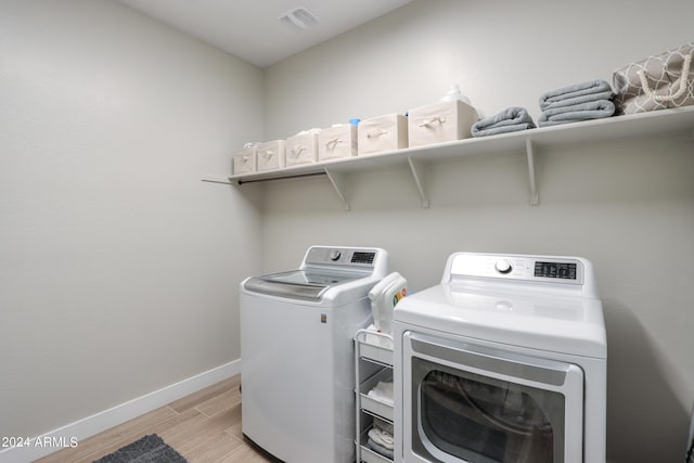 clothes washing area with washer and dryer