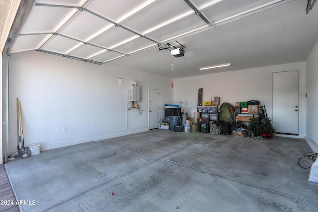 garage featuring tankless water heater and a garage door opener