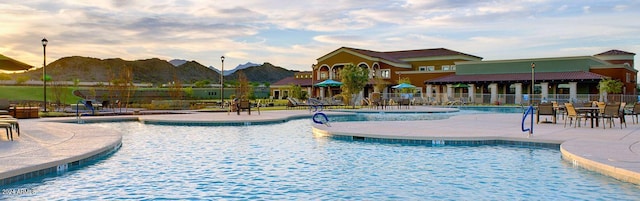 view of swimming pool with a mountain view and a patio