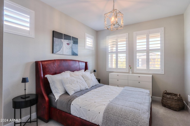 bedroom with carpet flooring, a chandelier, and multiple windows