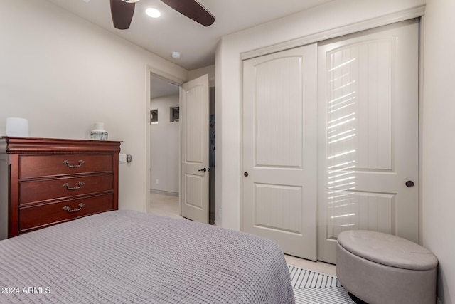 bedroom featuring ceiling fan and a closet