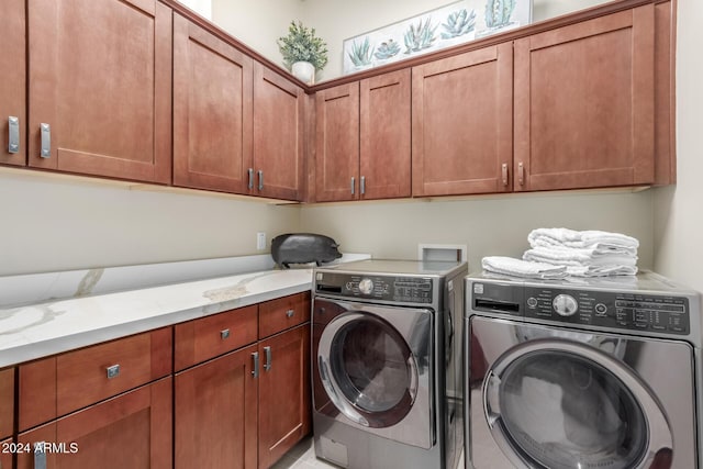 washroom featuring cabinets and separate washer and dryer