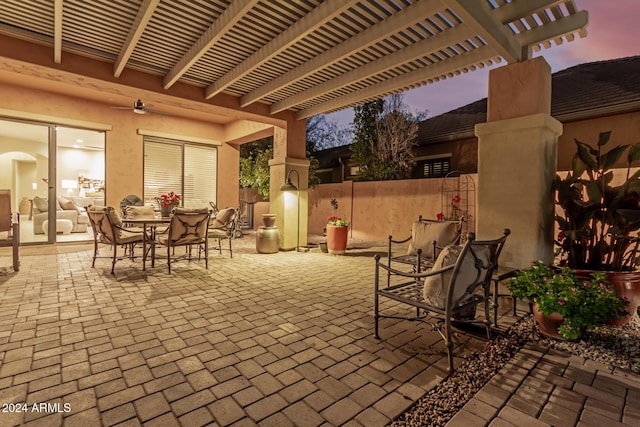 patio terrace at dusk featuring a pergola