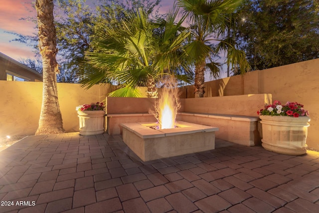 patio terrace at dusk with an outdoor fire pit