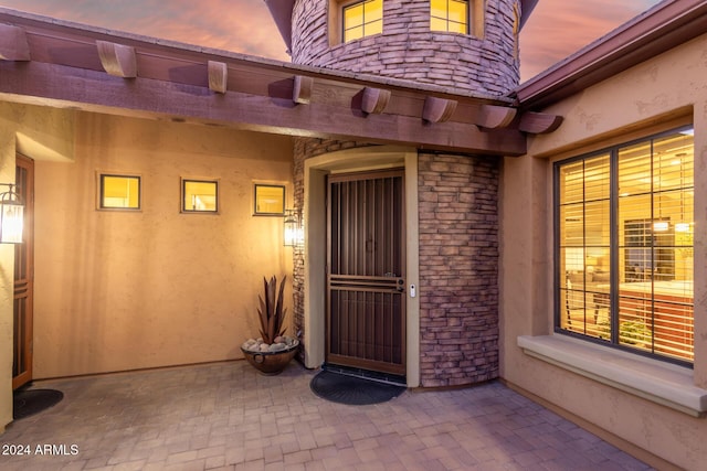 exterior entry at dusk with a patio