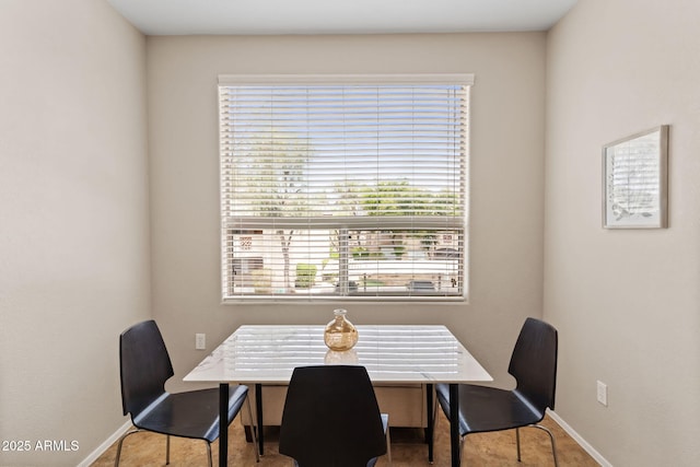 dining space featuring baseboards
