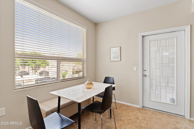 dining area featuring baseboards and light tile patterned floors