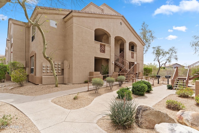 view of property with stairs and fence