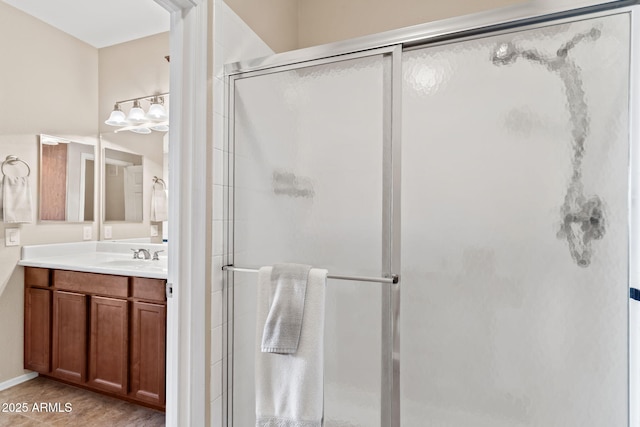 full bath featuring vanity and a shower stall