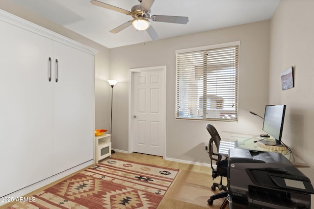 home office with baseboards and a ceiling fan