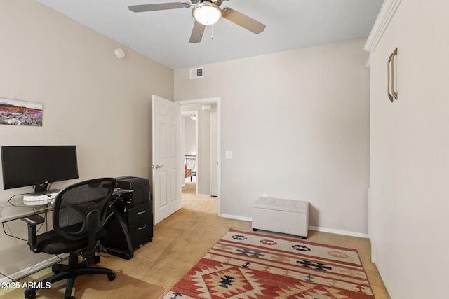 office space featuring ceiling fan, baseboards, light colored carpet, and visible vents