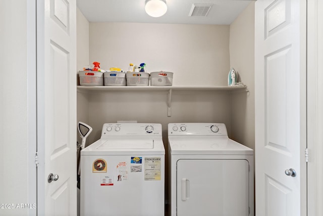 laundry room featuring independent washer and dryer, visible vents, and laundry area