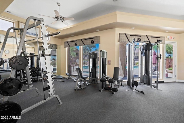gym featuring baseboards and a ceiling fan