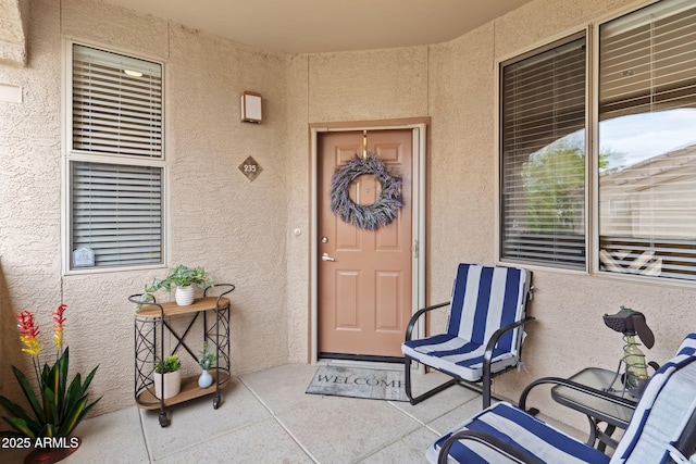 view of exterior entry with stucco siding