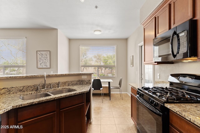 kitchen featuring baseboards, light stone countertops, a sink, black appliances, and light tile patterned floors