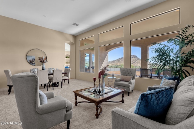 carpeted living room featuring a mountain view