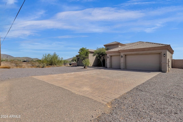 view of front of property featuring a mountain view and a garage