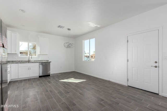 kitchen with dishwasher, dark wood-type flooring, a sink, and white cabinetry