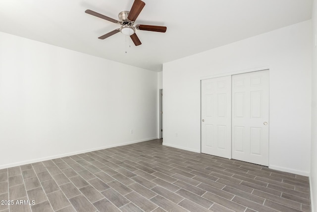 unfurnished bedroom with ceiling fan, baseboards, dark wood finished floors, and a closet