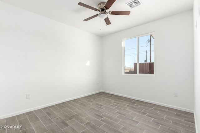 unfurnished room featuring visible vents, ceiling fan, baseboards, and wood finished floors