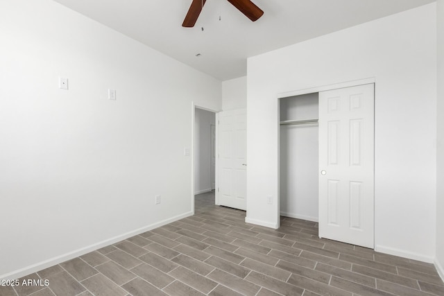 unfurnished bedroom with a closet, wood finished floors, a ceiling fan, and baseboards