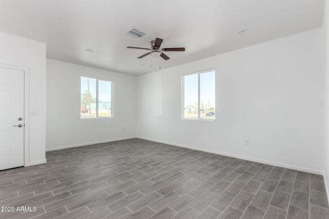 empty room featuring recessed lighting, visible vents, ceiling fan, wood finished floors, and baseboards