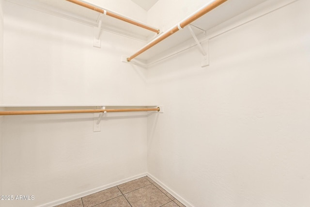 spacious closet with light tile patterned flooring