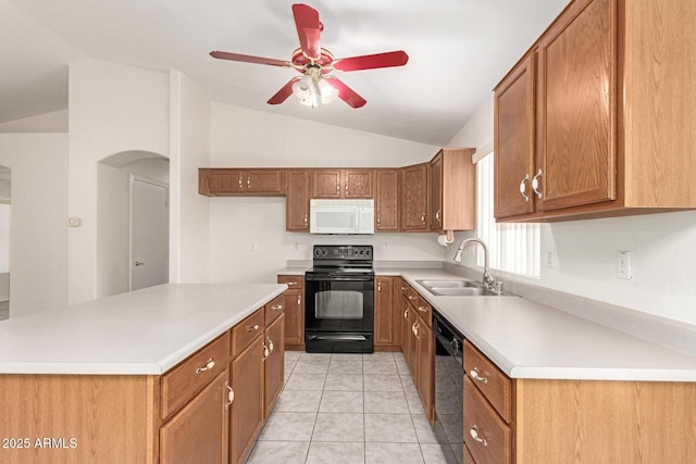 kitchen featuring a sink, black appliances, vaulted ceiling, light countertops, and brown cabinets