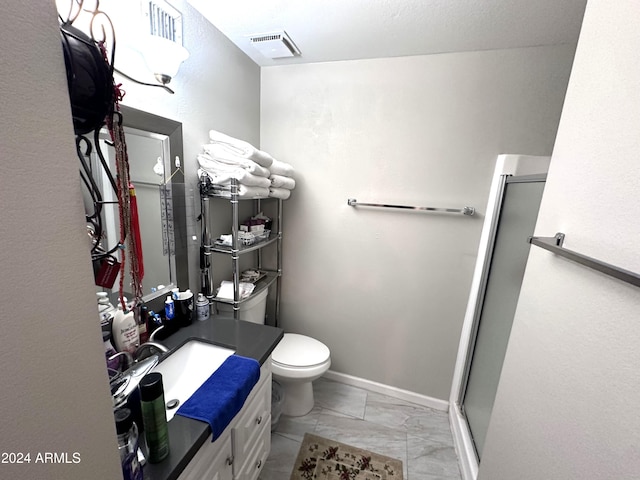 bathroom with vanity, toilet, and walk in shower