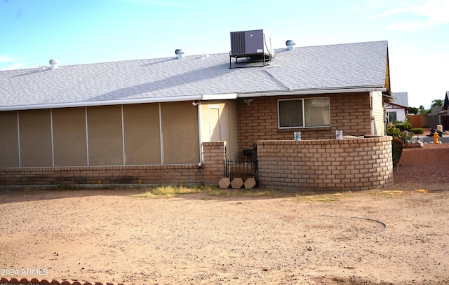 rear view of house featuring a sunroom