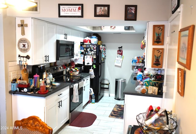 kitchen featuring white cabinets, backsplash, and appliances with stainless steel finishes