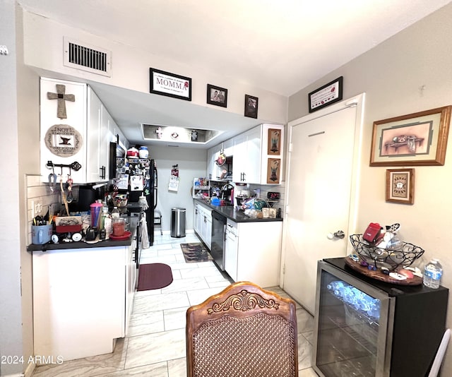 kitchen with dishwasher, wine cooler, and white cabinetry