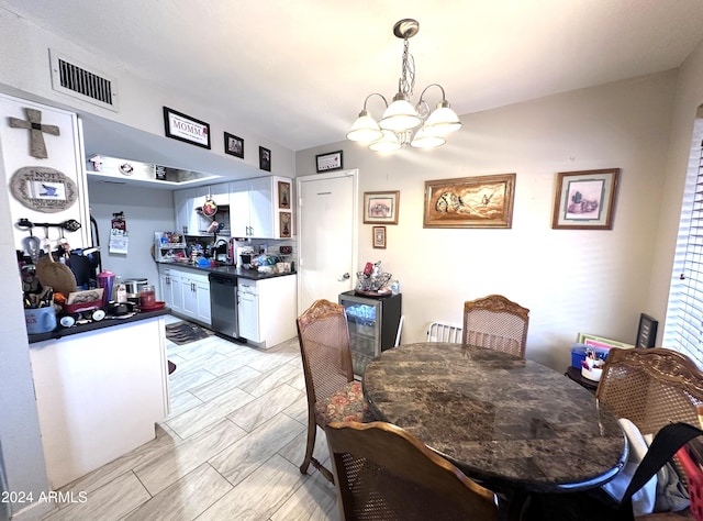 dining room featuring sink and a chandelier