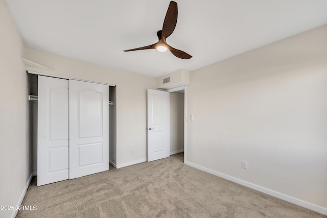 unfurnished bedroom with visible vents, ceiling fan, baseboards, carpet, and a closet