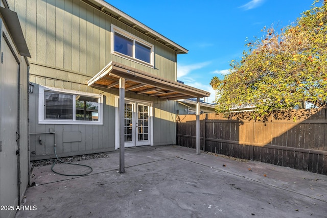 back of house with french doors, a patio, and fence