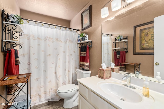 bathroom with vanity, hardwood / wood-style flooring, toilet, and a textured ceiling