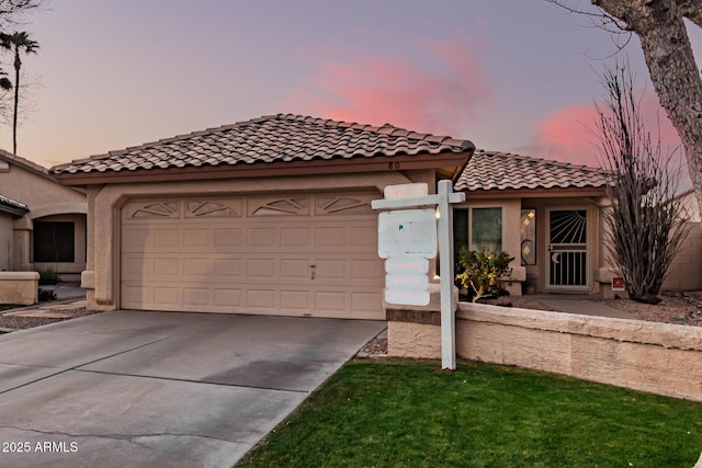 mediterranean / spanish-style house with a garage