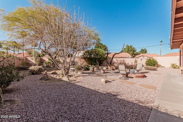 view of yard featuring a patio and an outdoor fire pit