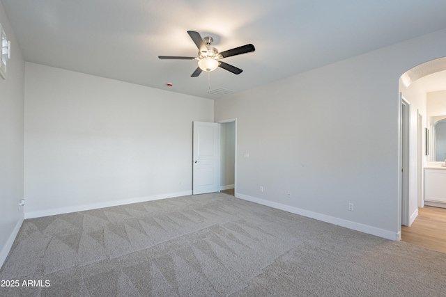 empty room with light colored carpet and ceiling fan