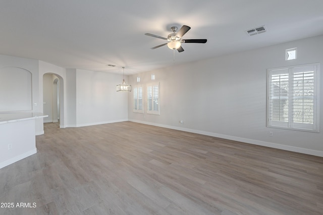 empty room with light hardwood / wood-style flooring and ceiling fan