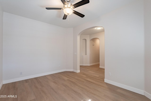 spare room with ceiling fan and light wood-type flooring